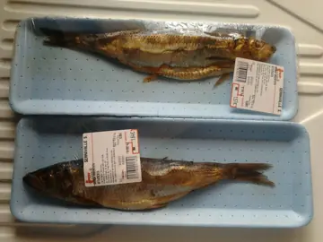 Whole smoked herring, packed for sale.